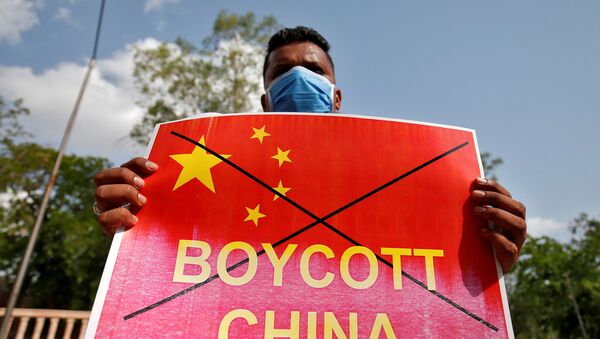 A member of National Students' Union of India (NSUI) holds a placard during a protest against China, in Ahmedabad, India, June 18, 2020. - Sputnik International