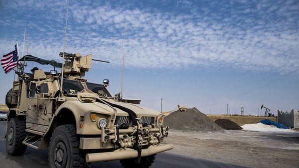 FILE - In this Monday, Oct. 28, 2019 file photo, U.S. forces patrol Syrian oil fields, in eastern Syria.President Donald Trump's decision to dispatch new U.S. forces to eastern Syria to secure oil fields is being criticized by some experts as ill-defined and ambiguous. But the residents of the area, one of the country's most remote and richest regions, hope the U.S. focus on eastern Syria would bring an economic boon and eliminate what remains of the Islamic State group - Sputnik International