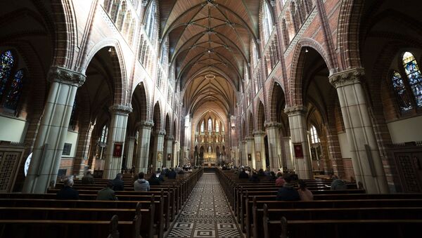 Visitors attend mass in the Vitus Church in Hilversum on 11 October 2020, amid the coronavirus pandemic. The bishops of the Roman Catholic Church in the Netherlands are asking parishes and religious communities to scale down gatherings as soon as possible to a maximum of 30 attendees in the upcoming liturgical celebrations - Sputnik International