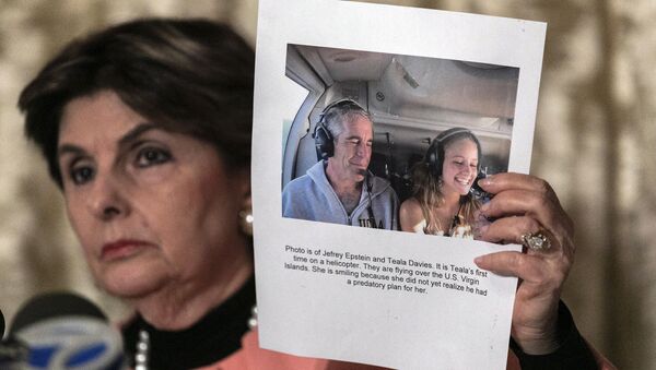 Attorney Gloria Allred, holds a picture of Jeffrey Epstein and her client Teala Davis during a news conference, Thursday, Nov. 21, 2019, in New York, about the filing of a lawsuit against the estate of Epstein. Davies says she was 17 when she was victimized by Epstein - Sputnik International