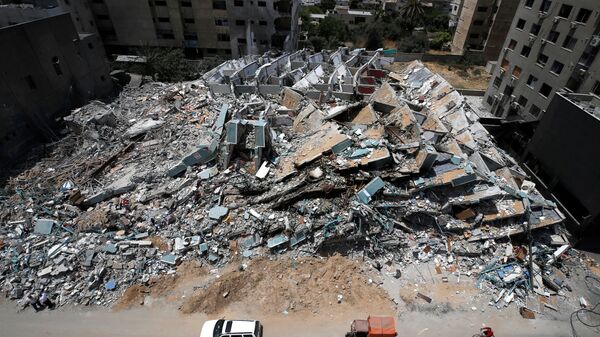 A view shows the remains of a tower building destroyed by Israeli missile strikes in the recent cross-border violence between Palestinian militants and Israel, following Israel-Hamas truce, in Gaza City May 21, 2021 - Sputnik International