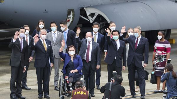 Taiwan's Foreign Minister Joseph Wu, fourth from right, waves with U.S. senators to his right Democratic Sen. Christopher Coons of Delaware, a member of the Foreign Relations Committee, Democratic Sen. Tammy Duckworth of Illinois and Republican Sen. Dan Sullivan of Alaska, members of the Armed Services Committee on their arrival at the Songshan Airport in Taipei, Taiwan on Sunday, June 6, 2021 - Sputnik International