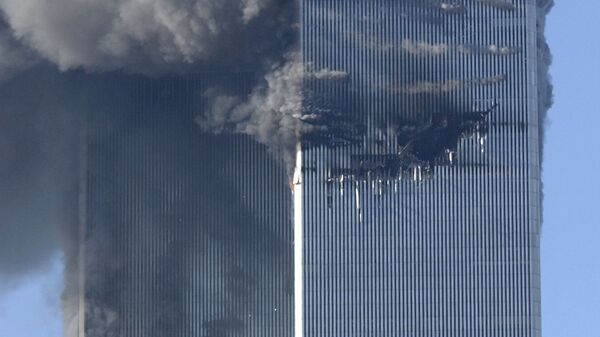 Smoke billows from the North and South Towers of the World Trade Center before they collapsed on September 11, 2001 in New York, NY - Sputnik International