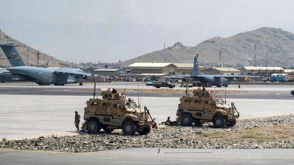FILE PHOTO: FILE PHOTO: U.S. Army soldiers assigned to the 82nd Airborne Division patrol Hamid Karzai International Airport in Kabul, Afghanistan August 17, 2021. Picture taken August 17, 2021.  U.S. Air Force/Senior Airman Taylor Crul/Handout via REUTERS  THIS IMAGE HAS BEEN SUPPLIED BY A THIRD PARTY. THIS PICTURE WAS PROCESSED BY REUTERS TO ENHANCE QUALITY. AN UNPROCESSED VERSION HAS BEEN PROVIDED SEPARATELY./File Photo/File Photo - Sputnik International