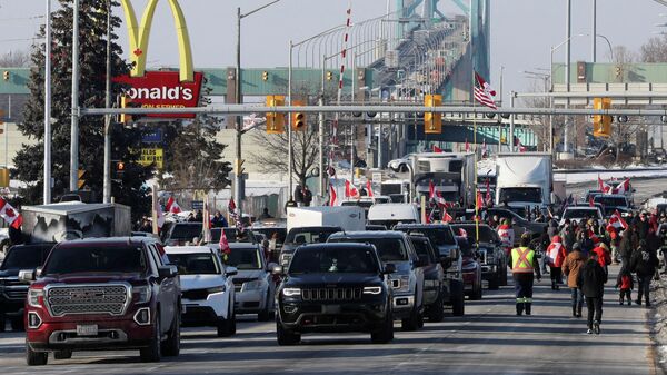 Vehicles block the route leading from the Ambassador Bridge, linking Detroit and Windsor, as truckers and their supporters continue to protest against the coronavirus disease (COVID-19) vaccine mandates, in Windsor, Ontario, Canada February 8, 2022.  - Sputnik International