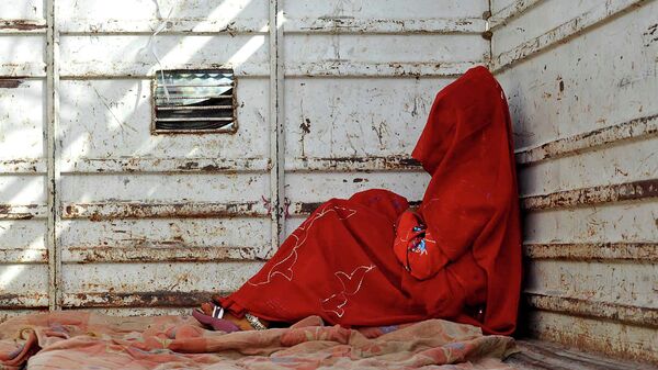 In this May 7, 2011 file photo, 7-year-old child bride sits in the back of a truck as she waits for the rest of her family members after being wed, at Biaora, about 135 kilometers from Bhopal, India. - Sputnik International