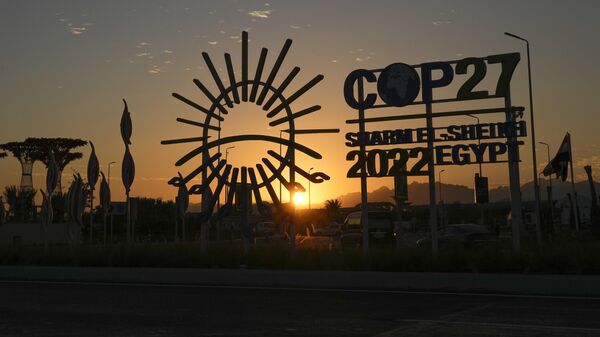 The sun sets behind the COP27 logo outside the venue of the COP27 U.N. Climate Summit, Saturday, Nov. 12, 2022, in Sharm el-Sheikh, Egypt. - Sputnik International