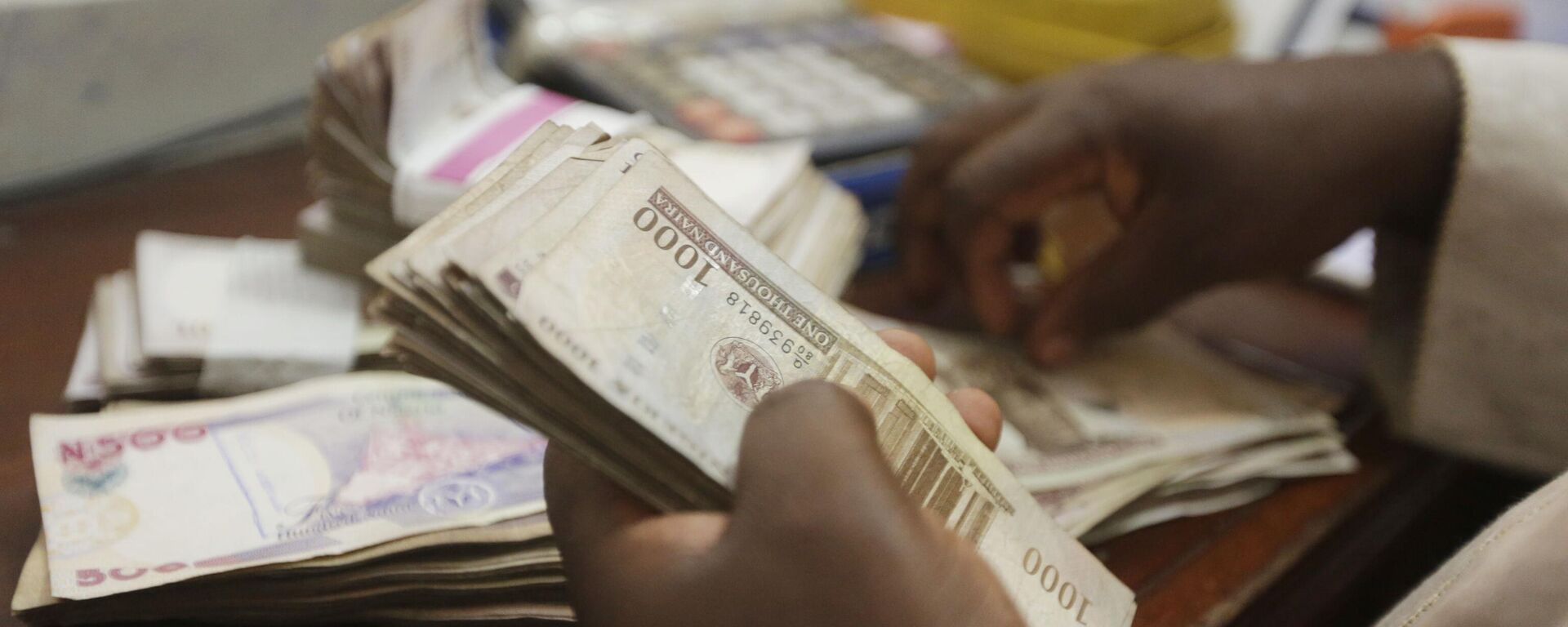 A money changer counts Nigerian naira currency at a bureau de change, in Lagos Nigeria, Oct. 20, 2015 - Sputnik International, 1920, 30.03.2023