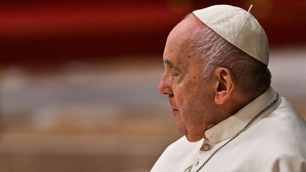 Pope Francis, seated in a wheelchair, leaves after leading the Easter Vigil mass on April 8, 2023 at St. Peter's basilica in The Vatican, as part of celebrations of the Holy Week. - Sputnik International