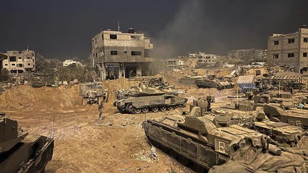 In this undated photo provided by the Israeli military, Israeli armored personnel carriers are seen during a ground operation in the Gaza Strip. Israeli ground forces have been operating in Gaza in recent days as Israel presses ahead with its war against Hamas militants - Sputnik International