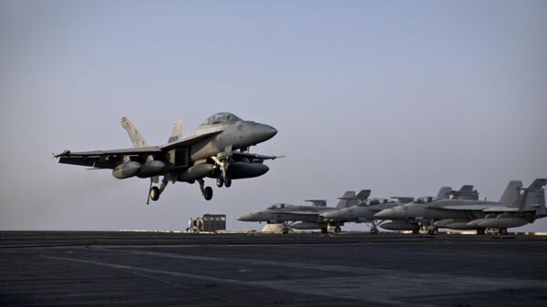 A U.S. Navy fighter jet is about to land on the flight deck of USS Theodore Roosevelt aircraft carrier, Thursday, Sept. 10, 2015 - Sputnik International