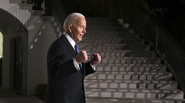 US President Joe Biden gestures as he departs the White House for the US Capitol to deliver the State of the Union address, in Washington, DC, on March 7, 2024.  - Sputnik International