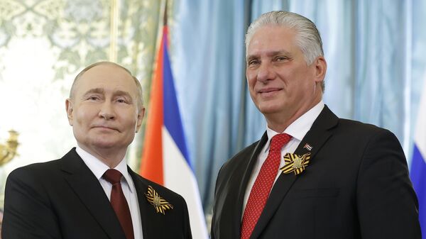 Russian President Vladimir Putin, left, and Cuban President Miguel Diaz-Canel pose for a photo during their meeting at the Great Kremlin Palace at the Kremlin in Moscow, Russia, on Thursday, May 9, 2024 - Sputnik International