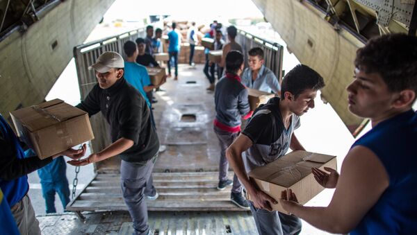 Unloading Russian EMERCOM plane with humanitarian aid which arrived to Latakia Airport in Syria. File photo - Sputnik International