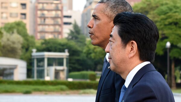 US President Barack Obama (L) and Japanese Prime Minister Shinzo Abe (R) walk towards the Atomic Bomb Dome after laying wreath in the Peace Momorial park in Hiroshima on May 27, 2016 - Sputnik International