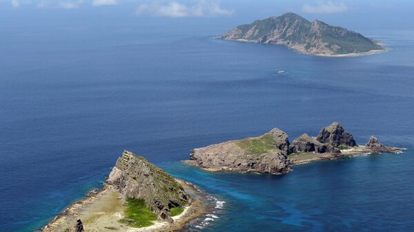 A group of disputed islands, Uotsuri island (top), Minamikojima (bottom) and Kitakojima, known as Senkaku in Japan and Diaoyu in China is seen in the East China Sea (File) - Sputnik International