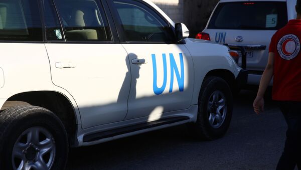 Vehicles of a UN and SARC aid convoy, with food, nutrition, health and other emergency items, enter the rebel-held town of Douma, east of the Syrian capital Damascus, on June 10, 2016 - Sputnik International