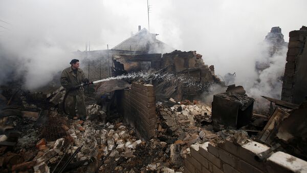 A firefighter douses a fire in Avdiivka after heavy shelling  (File) - Sputnik International