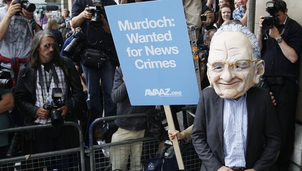 A protester wearing a Rupert Murdoch mask is photographed by media outside parliament in London, Tuesday, July 19, 2011.  - Sputnik International