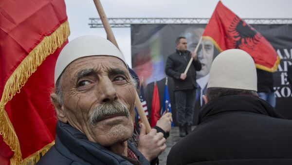 Protesters waving an Albanian flag looks on during a protest demanding immediate release from French judicial supervision of Ramush Haradinaj, Kosovo's former prime minister and a former guerrilla fighter, in Kosovo's capital Pristina on Saturday, Jan 21, 2017 - Sputnik International