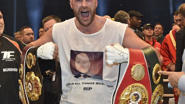 In this 29 November 2015 file photo, Britain's new world champion Tyson Fury celebrates with the WBA, IBF, WBO and IBO belts after winning the world heavyweight title fight against Ukraine's Wladimir Klitschko in Duesseldorf, western Germany.  - Sputnik International