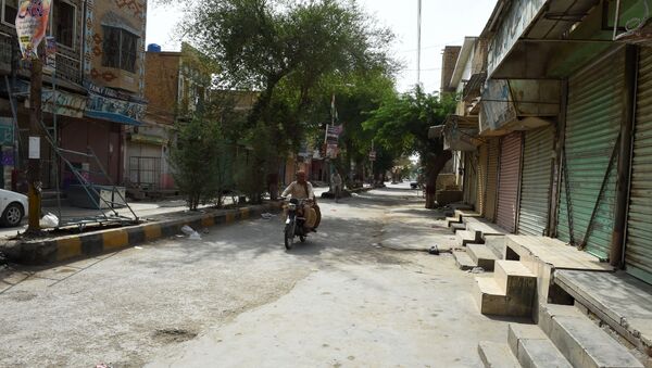 Pakistani motorcyclist drives through a closed market during a hot day in Sibi, in Pakistan's southwestern Balochistan province. (File) - Sputnik International