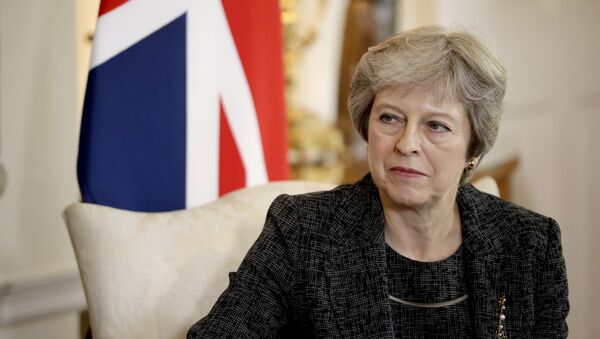 British Prime Minister Theresa May listens at the start of her meeting with the Emir of Qatar Tamim bin Hamad Al Thani inside 10 Downing Street in London, Tuesday, July 24, 2018 - Sputnik International
