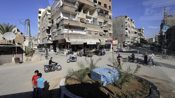 In a picture taken through a bus window, people drive their motorcycles in Damascus, Syria, Monday, Aug. 13, 2018 - Sputnik International