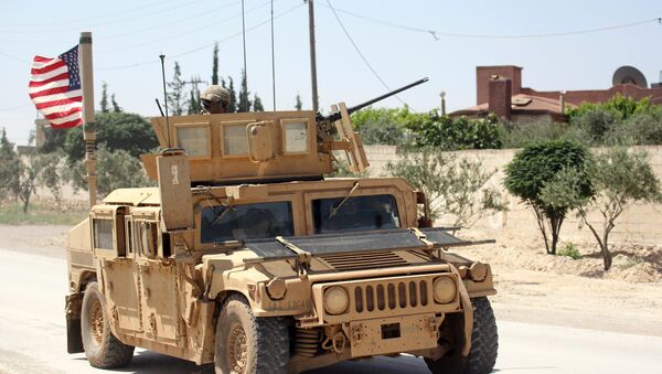 The U.S. flag flutters on a military vehicle in Manbej countryside, Syria May 12, 2018 - Sputnik International
