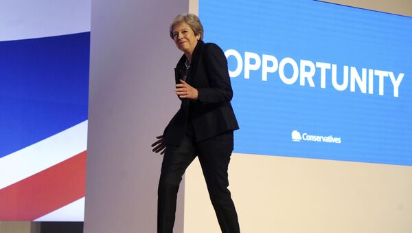 Conservative Party Leader and Prime Minister Theresa May dances as she arrives on stage to address delegates during a speech at the Conservative Party Conference at the ICC, in Birmingham, England, Wednesday, Oct. 3 , 2018. - Sputnik International