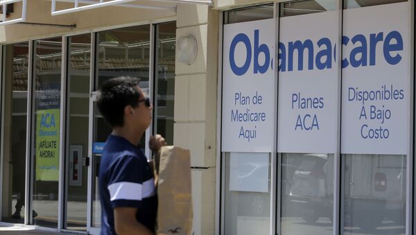 A man walks by a healthcare insurance office in Hialeah, Florida - Sputnik International