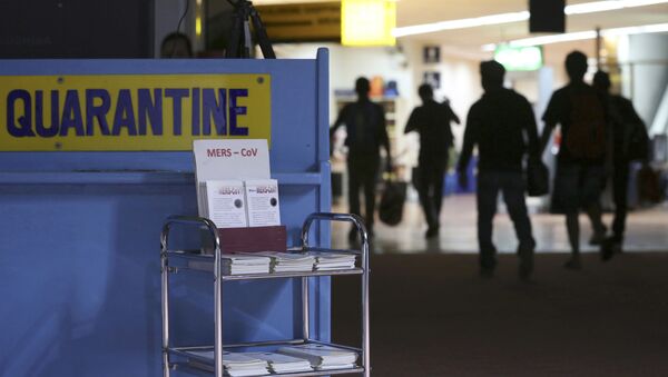 Passengers walk past the medical quarantine area showing information sheets for the Middle East respiratory syndrome coronavirus (File) - Sputnik International