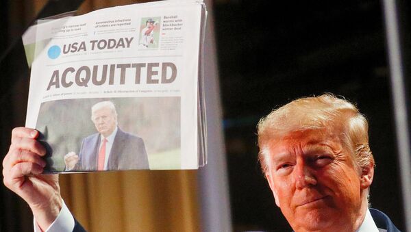 US President Donald Trump holds up a copy of USA Today's front page, showing news of his acquittal in his Senate impeachment trial, as he arrives to address the National Prayer Breakfast in Washington, 6 February 2020. - Sputnik International